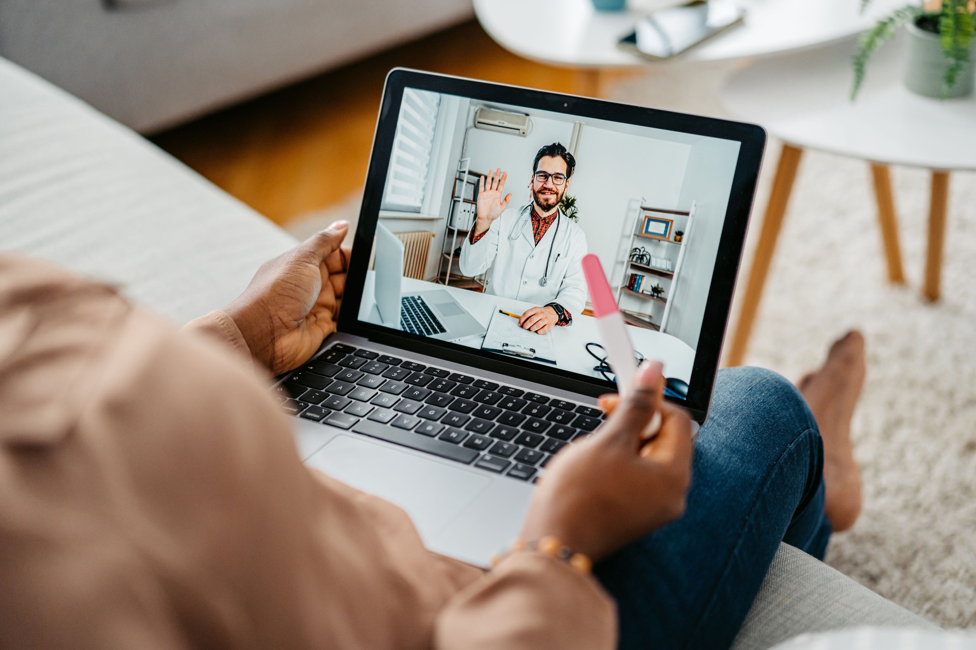 Young Pregnant Woman Having A Doctor's Appointment On A Laptop